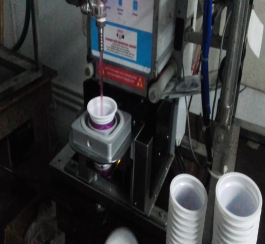 PLASTIC CUP FILLING AND SEALING MACHINE